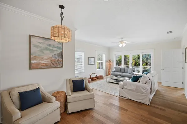 a living room with furniture a large window and a flat screen tv