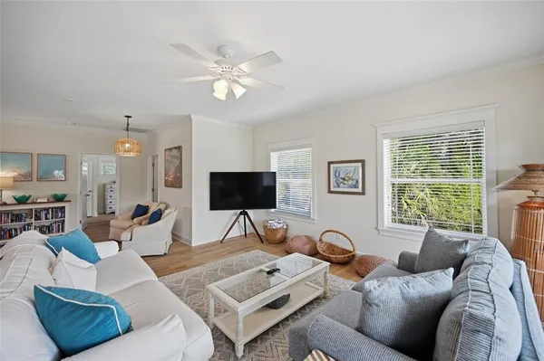 a living room with furniture and a chandelier