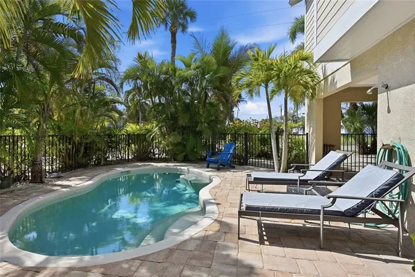 a view of a patio with couches table and chairs and potted plants