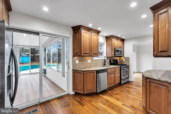 a kitchen with stainless steel appliances granite countertop a stove and a sink
