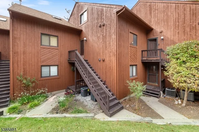 a view of staircase with railing and a chandelier