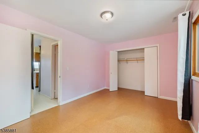 a balcony with wooden floor and city view