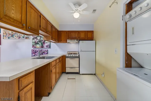 a kitchen with stainless steel appliances granite countertop a sink and cabinets