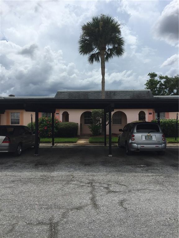 4126 Hampton Drive, Unit 4126 New Port Richey, FL 34652 - Photo 1 of 1 a front view of a house with garden
