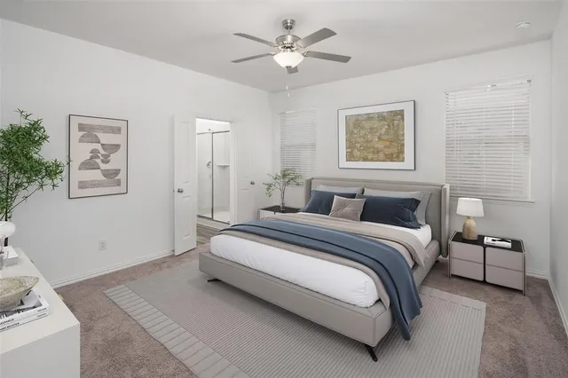 a spacious bedroom with a bed and a chandelier