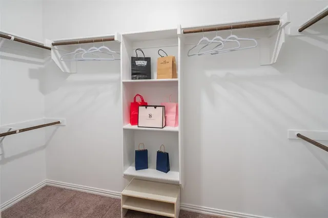 a hallway with storage and closet