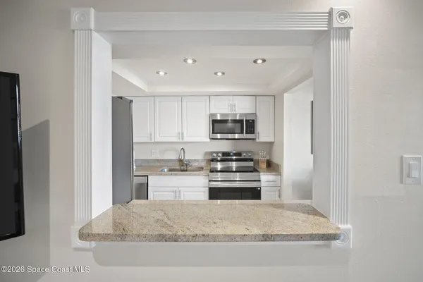 a view of a livingroom with a ceiling fan a ceiling fan and a large window