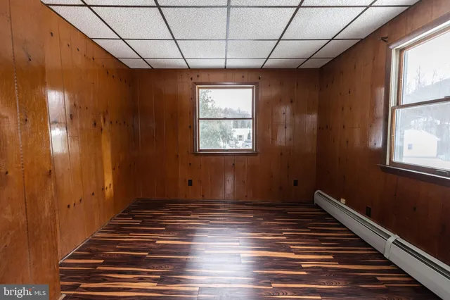 a view of a balcony with a dining table and chairs with wooden floor