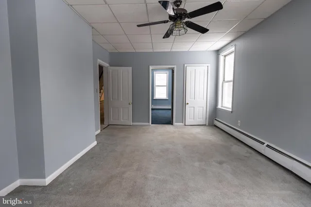 a view of snow on the road and trees