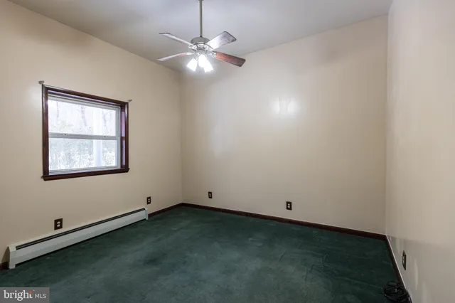 a kitchen with stainless steel appliances granite countertop a refrigerator a sink dishwasher a stove and white countertops with wooden floor