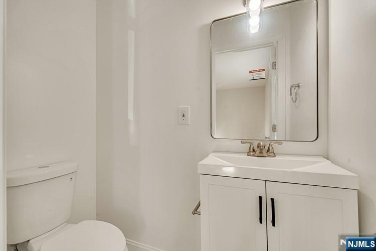 13 Casta Lane, Unit 1 Edgewater, NJ 07020 - Photo 13 of 25 a bathroom with a sink toilet and mirror