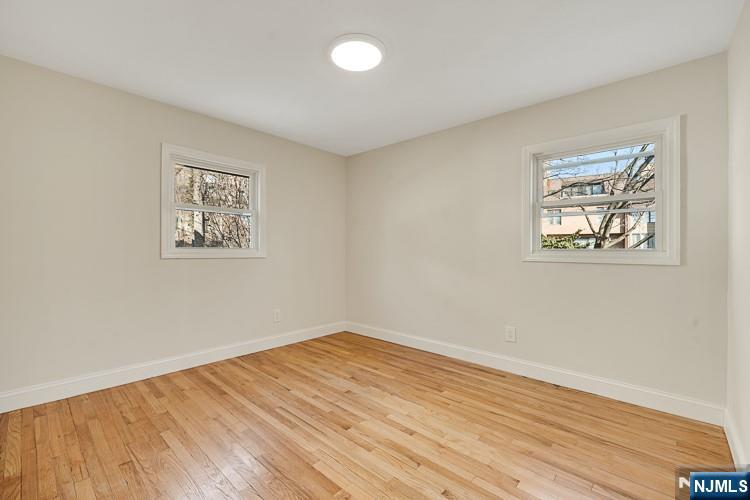 13 Casta Lane, Unit 1 Edgewater, NJ 07020 - Photo 14 of 25 a view of empty room with wooden floor