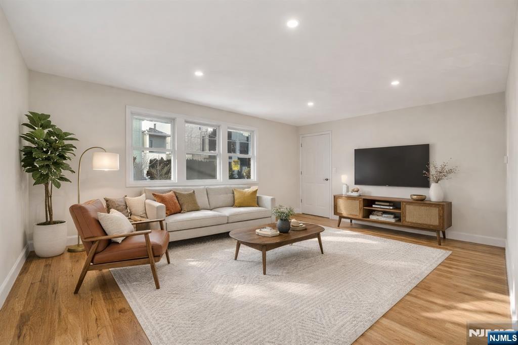 13 Casta Lane, Unit 1 Edgewater, NJ 07020 - Photo 2 of 25 a living room with furniture and a flat screen tv