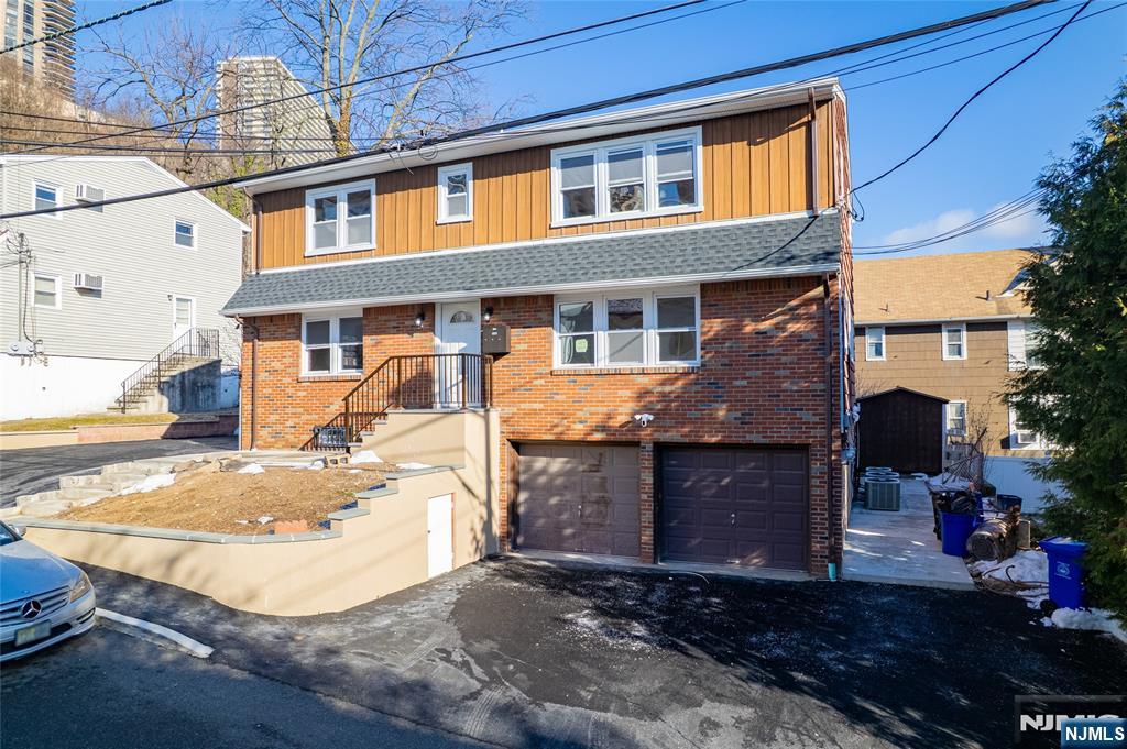 13 Casta Lane, Unit 1 Edgewater, NJ 07020 - Photo 22 of 25 a view of a brick house with many windows