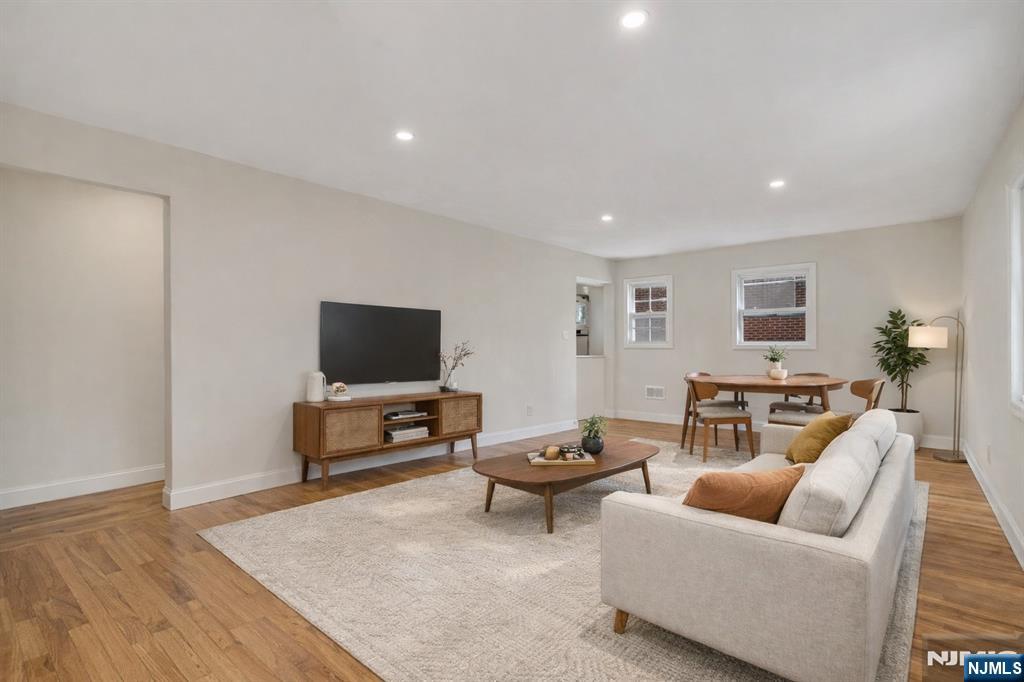 13 Casta Lane, Unit 1 Edgewater, NJ 07020 - Photo 4 of 25 a living room with furniture and a flat screen tv
