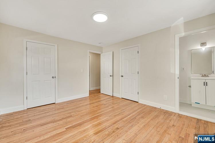 13 Casta Lane, Unit 1 Edgewater, NJ 07020 - Photo 9 of 25 a view of an empty room with wooden floor
