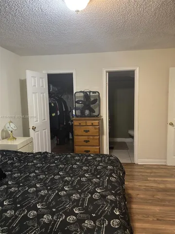 a bedroom with a bed and a cabinets