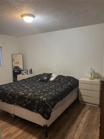 a bedroom with a bed and cabinets
