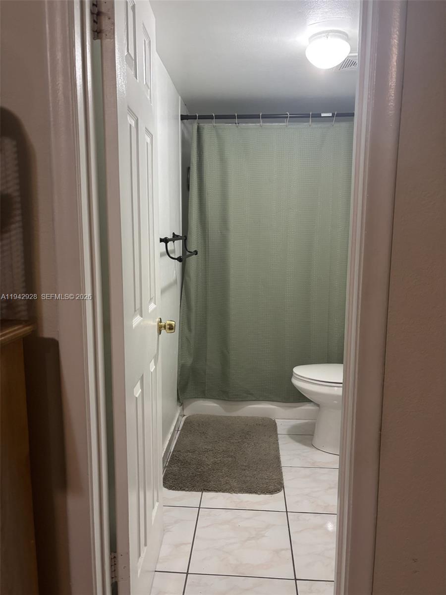 2565 West 56th Street, Unit 107 Hialeah, FL 33016 - Photo 8 of 15 a bathroom with a toilet and a shower