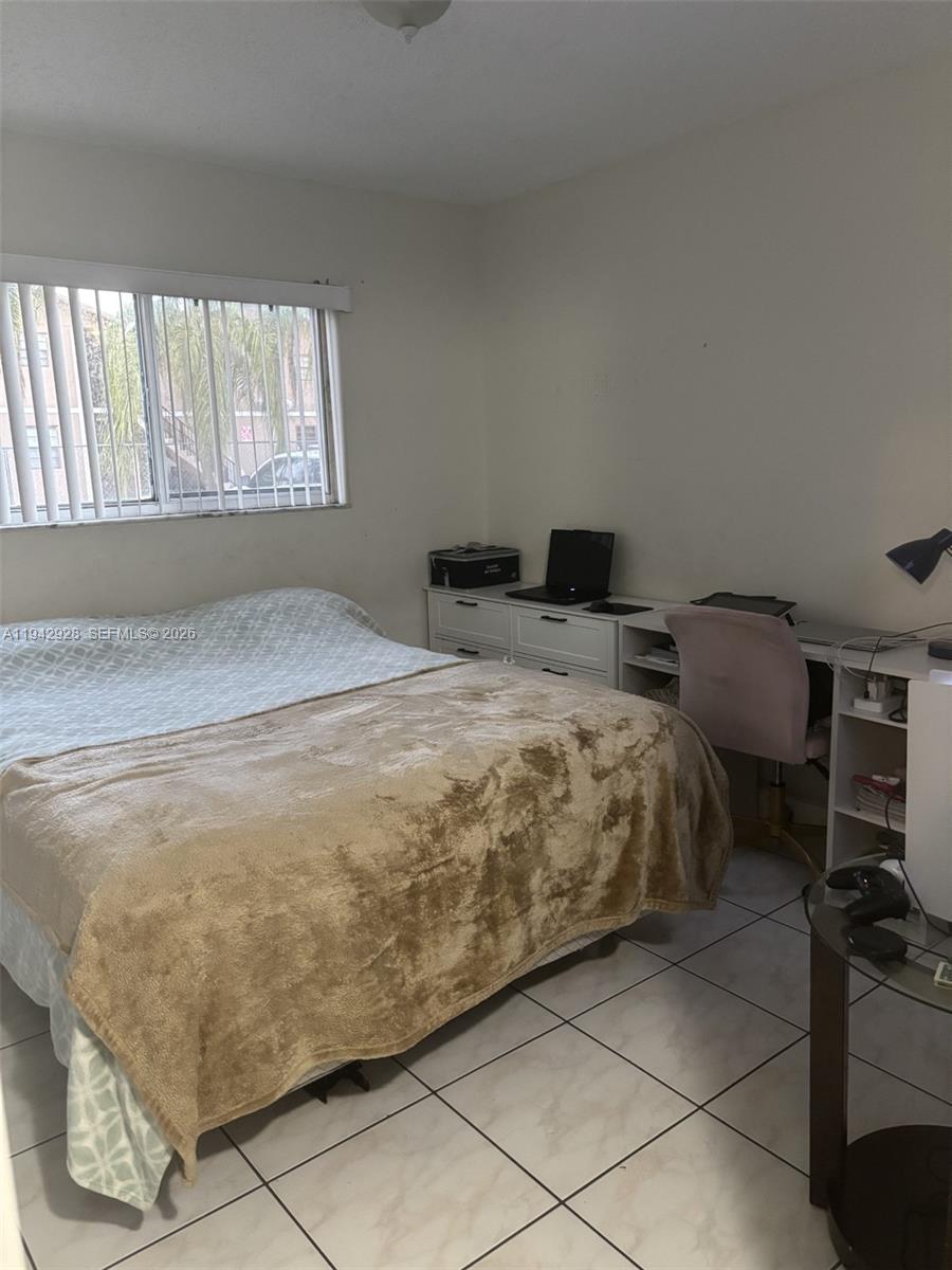 2565 West 56th Street, Unit 107 Hialeah, FL 33016 - Photo 9 of 15 a bedroom with a bed and a window
