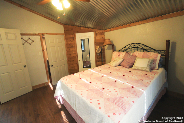 955 Faurie Road, Unit CEDAR CABIN Lakehills, TX 78063 - Photo 12 of 21 a bedroom with a bed and a mirror