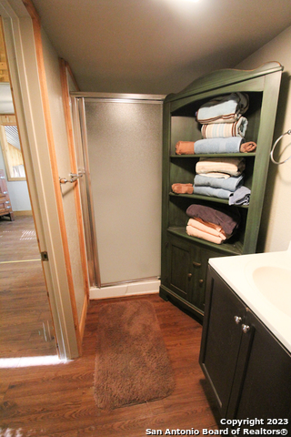 955 Faurie Road, Unit CEDAR CABIN Lakehills, TX 78063 - Photo 13 of 21 a view of an empty room with wooden floor and a window