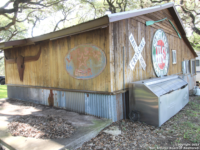 955 Faurie Road, Unit CEDAR CABIN Lakehills, TX 78063 - Photo 15 of 21 a wooden door with yard in the background