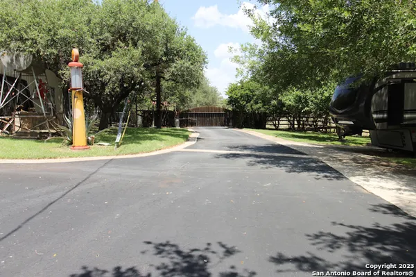 a view of a big house with a big yard and potted plants