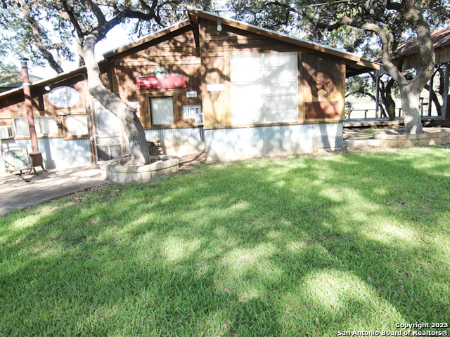 955 Faurie Road, Unit CEDAR CABIN Lakehills, TX 78063 - Photo 2 of 21 a view of yard with green space
