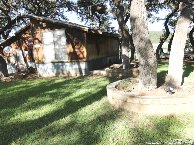 955 Faurie Road, Unit CEDAR CABIN Lakehills, TX 78063 - Photo 3 of 21 a backyard of a house with lots of green space