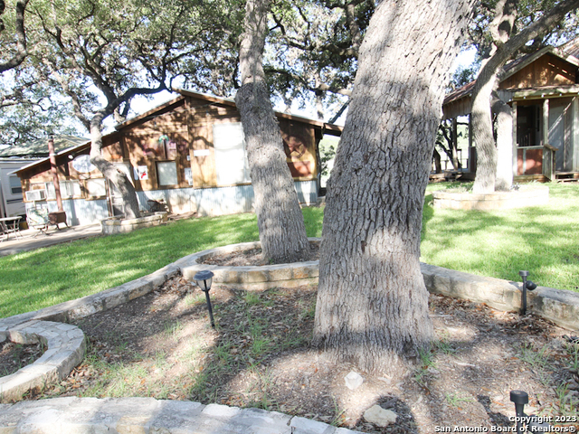 955 Faurie Road, Unit CEDAR CABIN Lakehills, TX 78063 - Photo 4 of 21 a view of backyard with green space