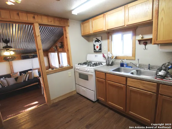 a kitchen with a sink cabinets appliances and a window