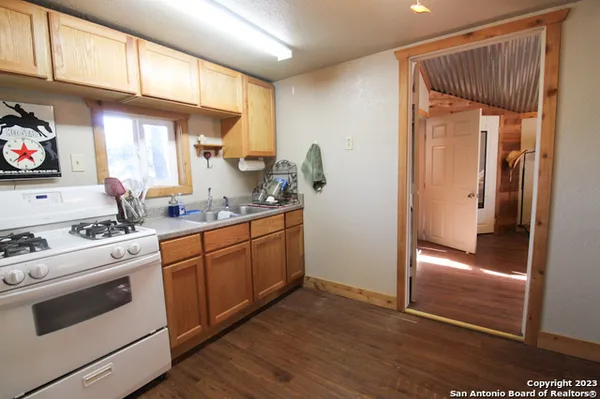 a kitchen with granite countertop white cabinets and white appliances