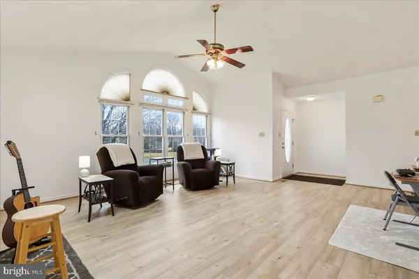 a view of a workspace with furniture and wooden floor