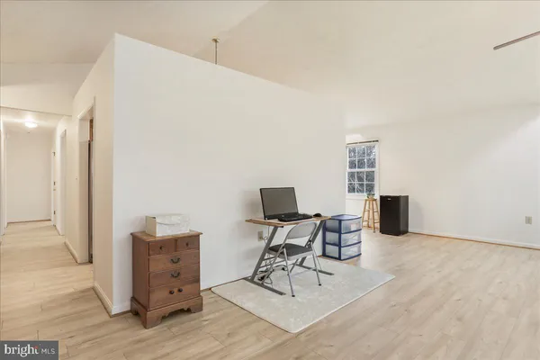 a kitchen with sink cabinets and living room view