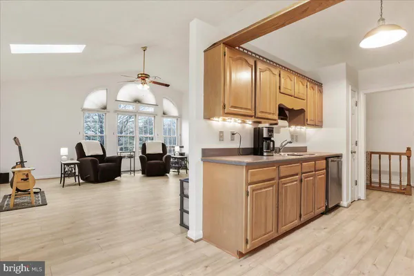 a kitchen with stainless steel appliances a stove microwave and sink