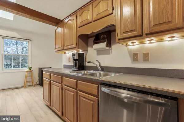 a kitchen with a refrigerator a sink and cabinets