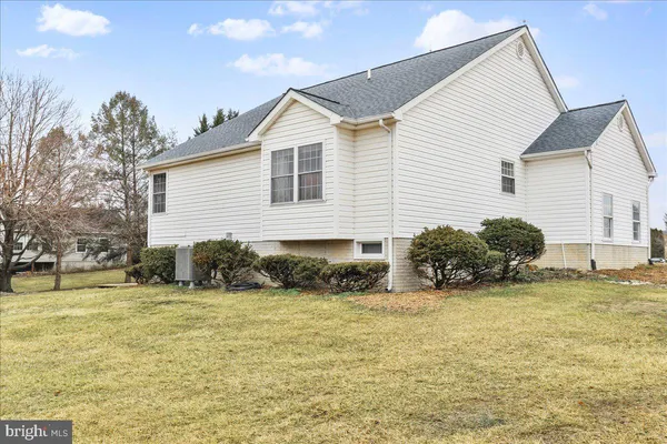 a view of a house with a yard and a chair