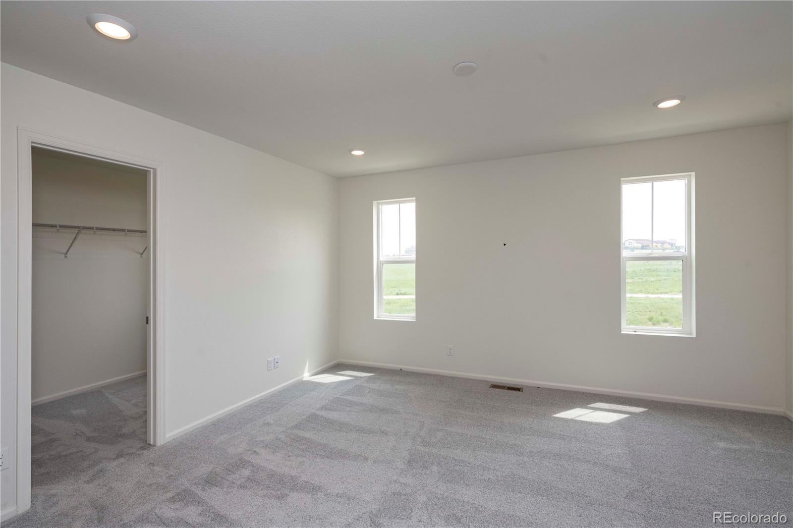 313 Rodden Drive Erie, CO 80516 - Photo 16 of 25 an empty room with windows