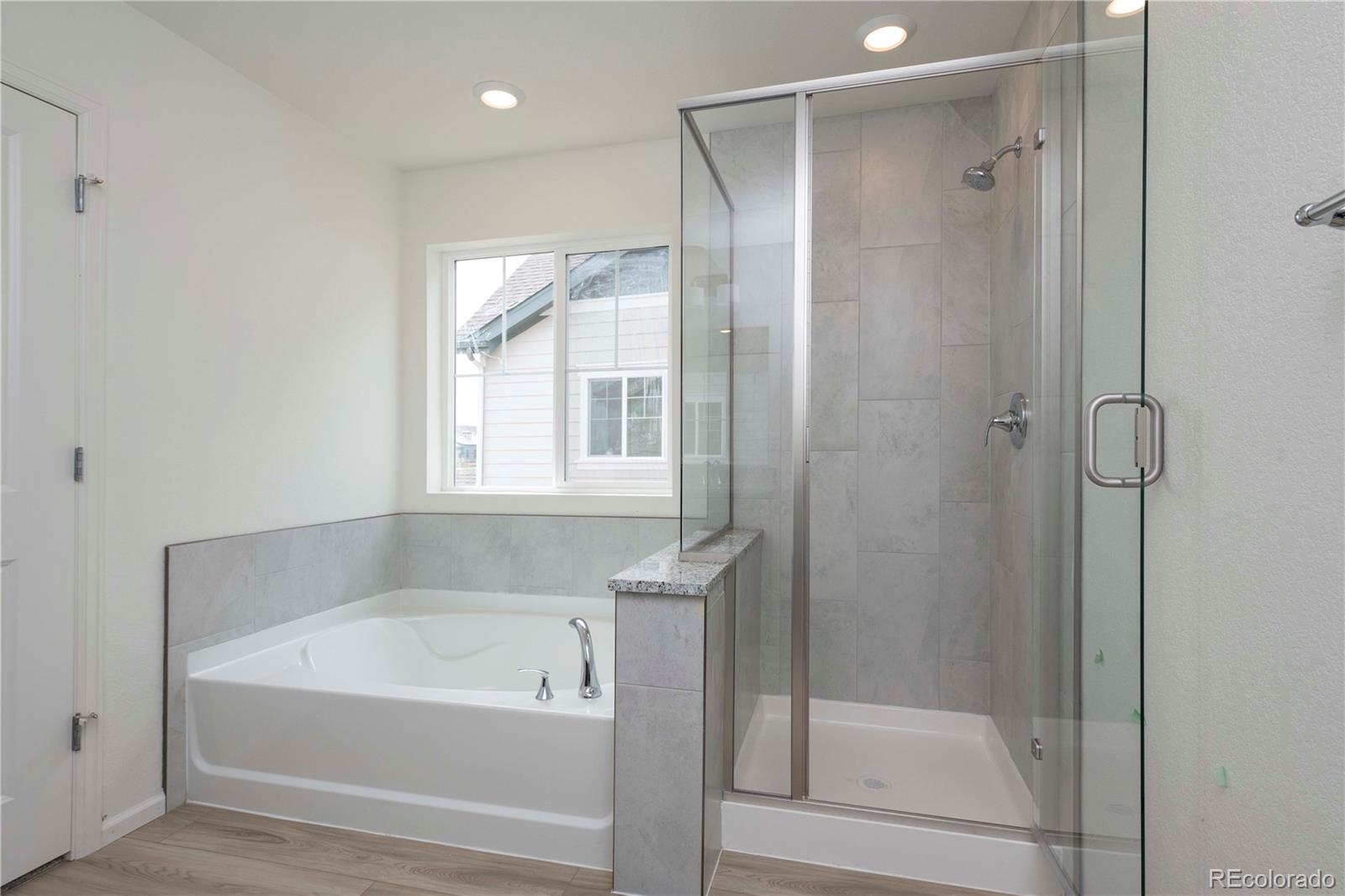 313 Rodden Drive Erie, CO 80516 - Photo 18 of 25 a bathroom with a bathtub and a shower