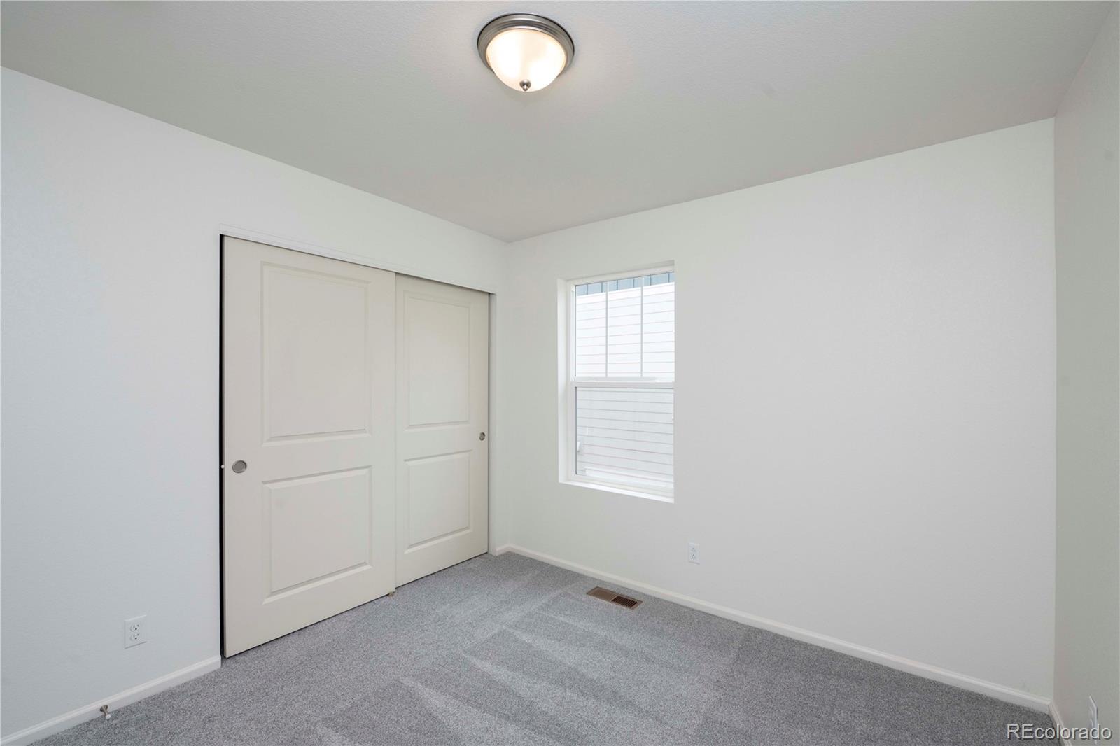 313 Rodden Drive Erie, CO 80516 - Photo 21 of 25 an empty room with windows