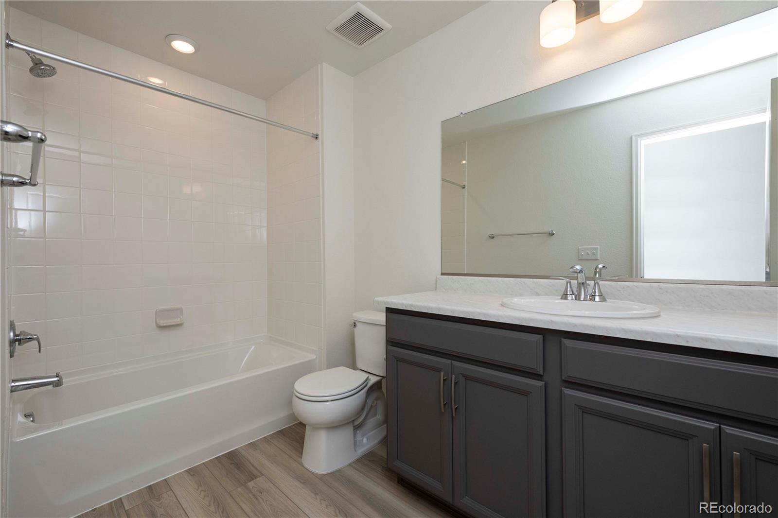 313 Rodden Drive Erie, CO 80516 - Photo 22 of 25 a bathroom with a sink a toilet and shower