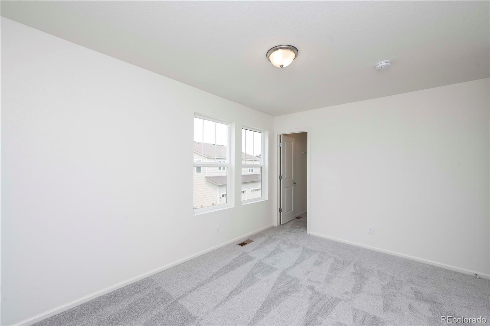 313 Rodden Drive Erie, CO 80516 - Photo 23 of 25 an empty room with windows