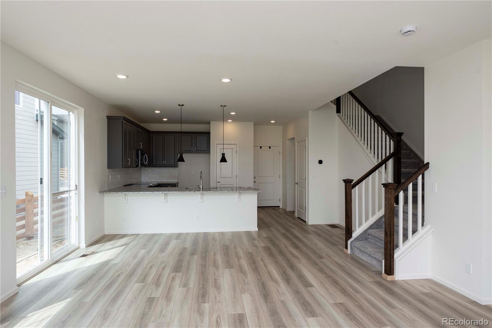 313 Rodden Drive Erie, CO 80516 - Photo 8 of 25 a view of kitchen with wooden floor and electronic appliances