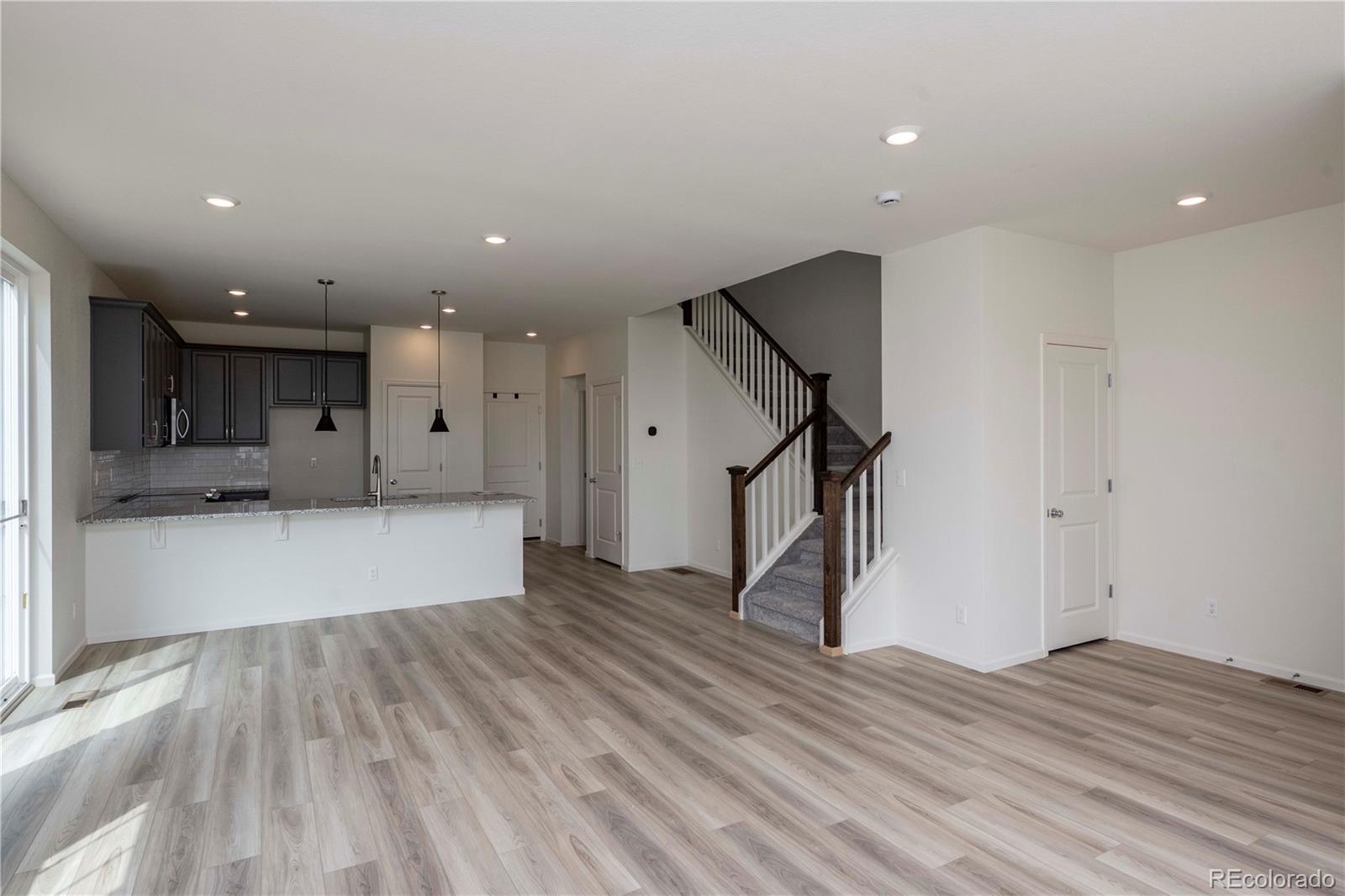 313 Rodden Drive Erie, CO 80516 - Photo 10 of 25 a view of a room with wooden floor and staircase