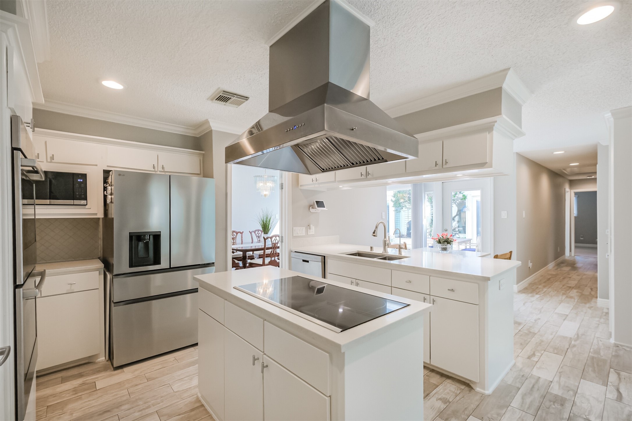 1007 Arrow Hill Road Houston, TX 77077 - Photo 12 of 48 The island kitchen features quartz counters with tile backsplash, crown molding, LED recessed lighting and plenty of cabinet and counter space!