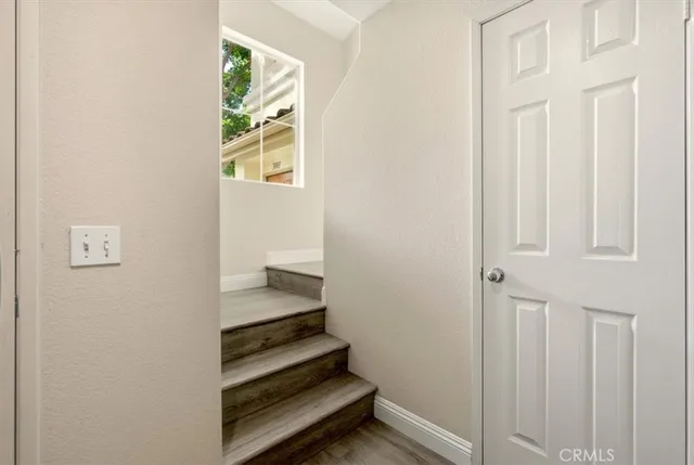 a view of a hallway with wooden floor and entryway