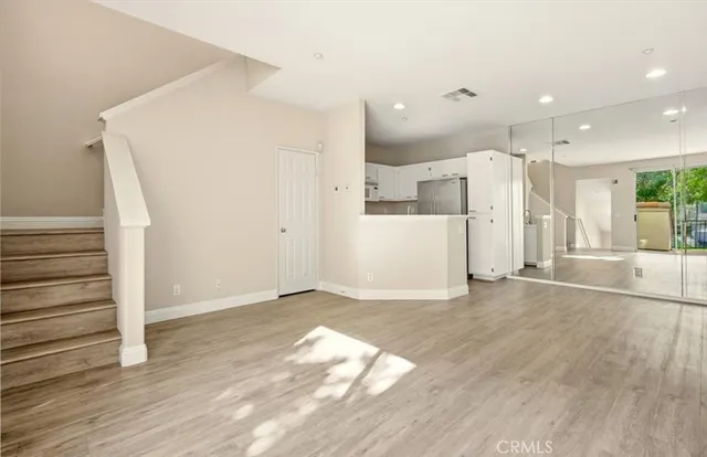 a view of a kitchen with wooden floor and a sink