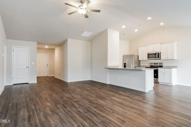 a view of kitchen with cabinets appliances and wooden floor
