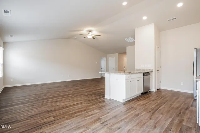 a view of kitchen with cabinets appliances and wooden floor